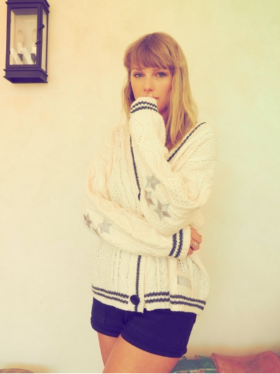 Taylor Swift wearing the same cardigan that she wore in the Cardigan music video.